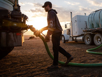 Farmer filling tank with fuel